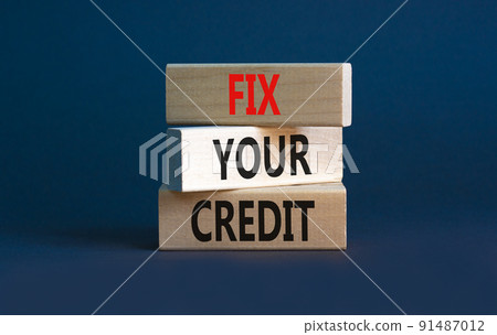 Fix your credit symbol. Concept words Fix your credit on wooden blocks on a beautiful grey table grey background. Business, finacial and fix your credit concept. Copy space. 91487012