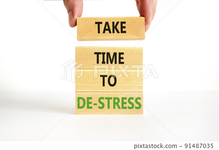 Take time to de-stress symbol. Concept words Take time to de-stress on wooden blocks. Beautiful white table white background. Psychological business and take time to de-stress concept. Copy space. 91487035