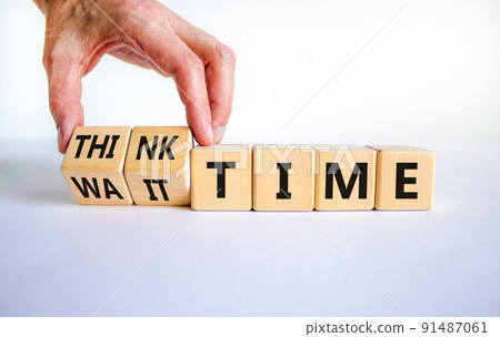 Think or wait time symbol. Businessman turns wooden cubes and changes words 'wait time' to 'think time'. Beautiful white background, copy space. Business and think or wait time concept. 91487061
