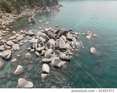 Crystal clear Lake Tahoe rocky shoreline  91487473