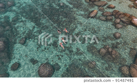 Lake Tahoe rocky shoreline. Ladies relaxing in the crystal clear water Lake Tahoe rocky shoreline. Ladies relaxing in the crystal clear water 91487491