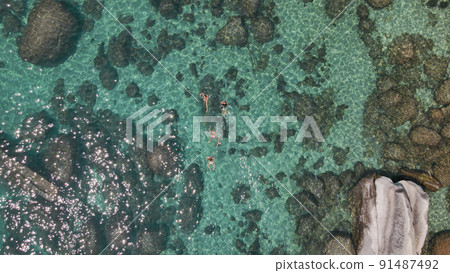 Lake Tahoe rocky shoreline. Ladies relaxing in the crystal clear water Lake Tahoe rocky shoreline. Ladies relaxing in the crystal clear water 91487492