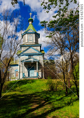Old wooden church in Open air Museum of Folk Architecture and Folkways of Middle Naddnipryanschina in Pereyaslav, Ukraine 91487805