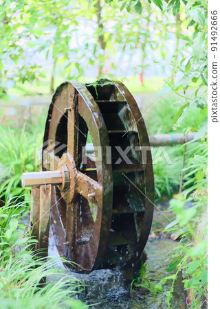 A small water wheel that turns and drains water 91492666