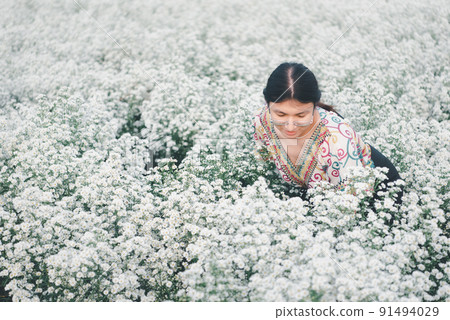 Woman (LGBTQ) posing at flower park garden field 91494029