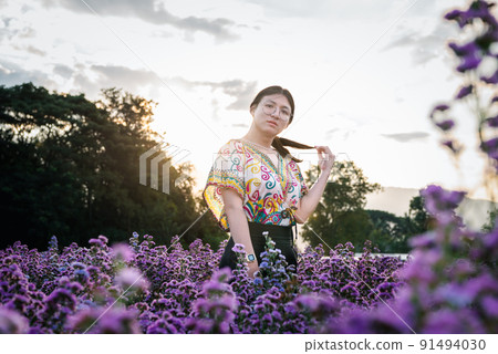 Woman (LGBTQ) posing at flower park garden field Woman (LGBTQ) posing at flower park garden field 91494030