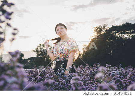Woman (LGBTQ) posing at flower park garden field Woman (LGBTQ) posing at flower park garden field 91494031