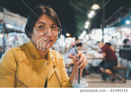Woman (LGBTQ) posing with food at thai street food 91494335