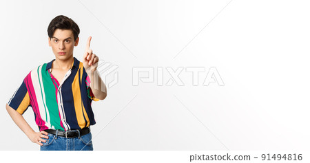 Disappointed young man prohibit something, shaking finger in disapproval, forbid you, standing over white background Disappointed young man prohibit something, shaking finger in disapproval, forbid you, standing over white background 91494816