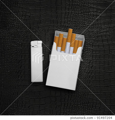 Cigarette pack and lighters on a black leather background 91497204