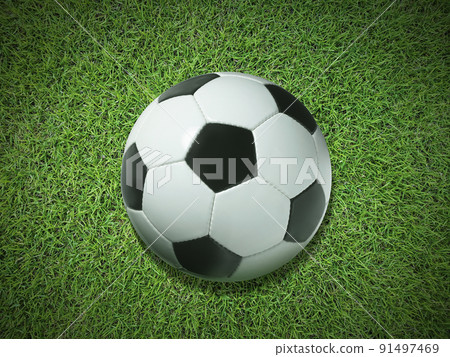 Traditional soccer ball on green grass, top view 91497469