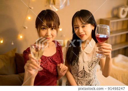 A woman toasting indoors A woman toasting indoors 91498247