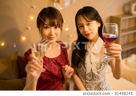 A woman toasting indoors A woman toasting indoors 91498248