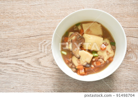 fried egg tofu with chop pork topping slice mushroom in sweet and sour gravy sauce on bowl 91498704