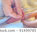 A photo comparing the size of a single grain with the little finger of a baby's foot 91499785
