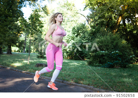 Girl jogging in the park in the morning. pretty running girl 91502658