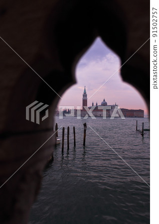Basilica of San Giorgio Maggiore peeking from the parapet of the Venice Bridge, Italy 91502757