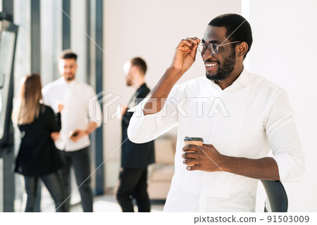 Portrait of african american male office worker in front of his colleagues Portrait of african american male office worker in front of his colleagues 91503009