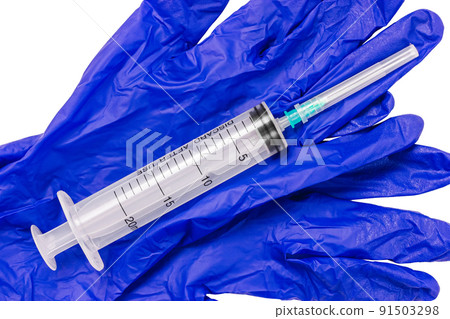 Medical syringe on blue sterile gloves. Used medical syringe. 91503298