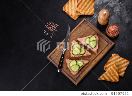 Delicious fresh sandwich with chicken liver pate with crispy toast, butter and cucumber 91507951