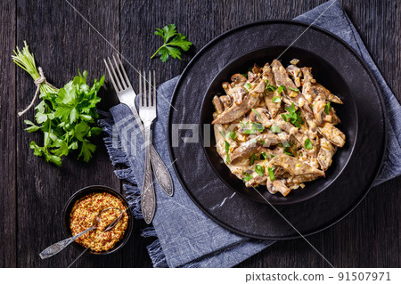 liver stroganoff in black bowl, top view liver stroganoff in black bowl, top view 91507971