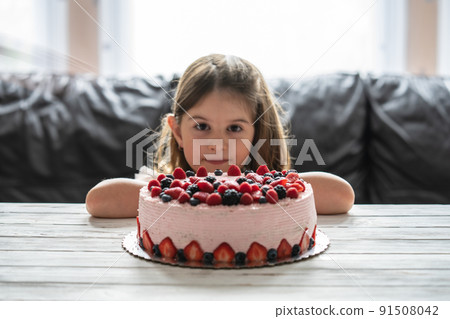 Little girl birthday cake.Home made cake with berries. Cake with Strawberry, blackberry, blueberry, and raspberry on a table Little girl birthday cake.Home made cake with berries. Cake with Strawberry, blackberry, blueberry, and raspberry on a table 91508042