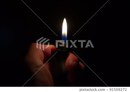 An image of a fire that illuminates the darkness with a lighter's fire An image of a fire that illuminates the darkness with a lighter's fire 91509272