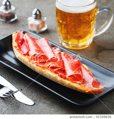 Traditional Spanish breakfast. Tostada with different toppings on a dark background Traditional Spanish breakfast. Tostada with different toppings on a dark background 91509636