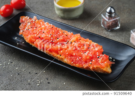 Traditional Spanish breakfast. Tostada with different toppings on a dark background 91509640