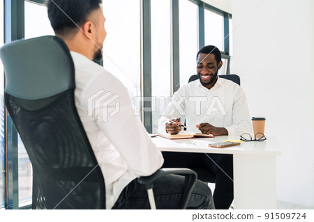Two multiracial businessmen at meeting in the office 91509724