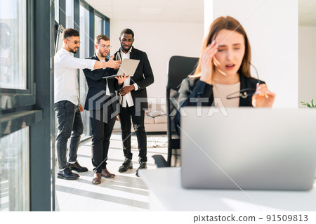 Female office worker holding her head. .Company employee is overworked Female office worker holding her head. .Company employee is overworked 91509813