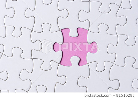 Piece of jigsaw puzzle on pink paper. Flat lay, Directly above. Piece of jigsaw puzzle on pink paper. Flat lay, Directly above. 91510295