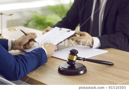 Professional lawyer providing legal services and helping his client with documents Professional lawyer providing legal services and helping his client with documents 91510303