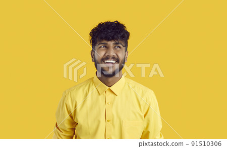 Happy guy with funny expression is thinking about new opportunities or imagining something nice. 91510306