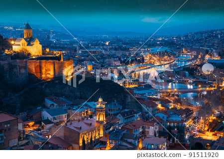 Tbilisi, Georgia. starry sky night sky above cityscape skyline, Scenic View Old Historic District Of Kala. Urban Night Cityscape. Evening Scenic. blue hour. altered sky. Elevated Top View Of Famous 91511920