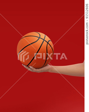 Hands and basketball isolated on red background Hands and basketball isolated on red background 91512606