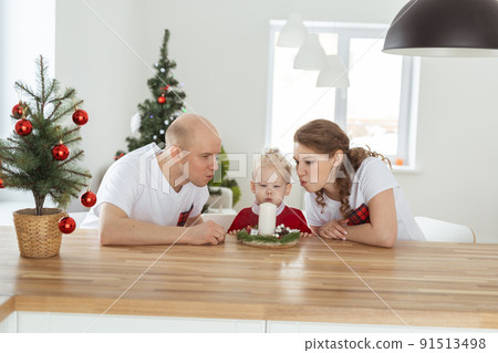 Child girl dressed in christmas dress with cochlear implants having fun at home - diversity and hearing aid and innovating technologies for treatment of deafness. 91513498