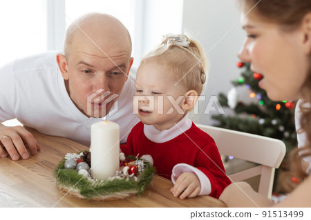 Child girl dressed in christmas dress with cochlear implants having fun at home - diversity and hearing aid and innovating technologies for treatment of deafness. 91513499