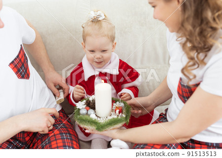 Baby child with hearing aid and cochlear implant having fun with parents in christmas room. Deaf , diversity and health concept Baby child with hearing aid and cochlear implant having fun with parents in christmas room. Deaf , diversity and health concept 91513513
