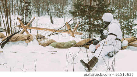 German Wehrmacht Infantry Soldier In World War II Soldiers Sitting In Ambush In Winter Forest. Historical Re-enactment. WWII. Winter Snowy Day. Black And White Photo 91513635