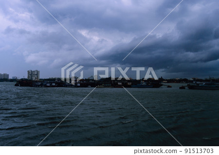 Kolkata Riverside Landscape View on a Dark cloudy day. View from Babu Ghat Footbridge. Kolkata West Bengal India South Asia 19 June 2022 91513703