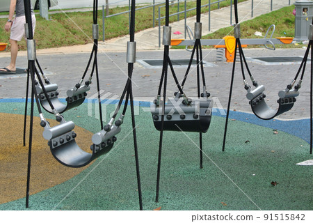 PENANG, MALAYSIA -MAY 8, 2022: Selected focused on modern children's outdoor playground in the public park. It was designed with a few different themes for kids to enjoy. Kids happy.  91515842