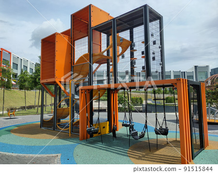 PENANG, MALAYSIA -MAY 8, 2022: Selected focused on modern children's outdoor playground in the public park. It was designed with a few different themes for kids to enjoy. Kids happy. PENANG, MALAYSIA -MAY 8, 2022: Selected focused on modern children's outdoor playground in the public park. It was designed with a few different themes for kids to enjoy. Kids happy. 91515844