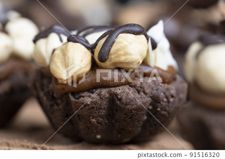 multicomponent cake made of caramel and nuts in chocolate multicomponent cake made of caramel and nuts in chocolate 91516320