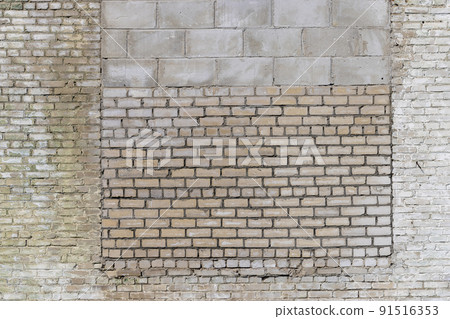 an old brick wall made of a large number of different types of bricks 91516353
