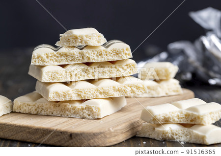 white porous chocolate on a wooden table 91516365