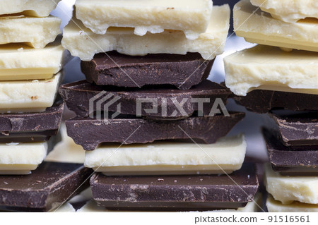 broken into pieces tiles of white and milk and dark chocolate broken into pieces tiles of white and milk and dark chocolate 91516561