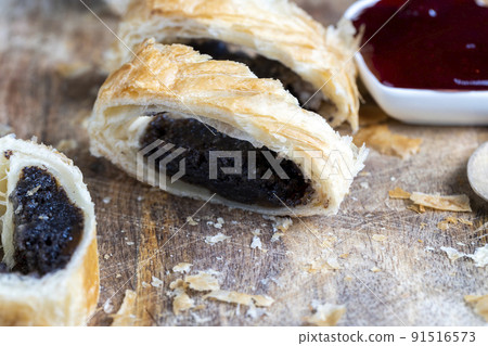 puff pastry bun made of wheat dough and poppy seed filling 91516573