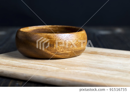 wooden plate on cutting board and black wooden table wooden plate on cutting board and black wooden table 91516735
