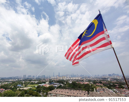 The Malaysian flag aka Jalur Gemilang is flown at a high place and against the backdrop of the Kuala Lumpur skyline The Malaysian flag aka Jalur Gemilang is flown at a high place and against the backdrop of the Kuala Lumpur skyline 91517553
